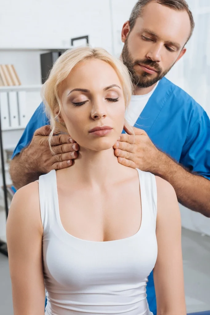 A woman being massaged by a therapist of Capstone Physical Therapy & Fitness