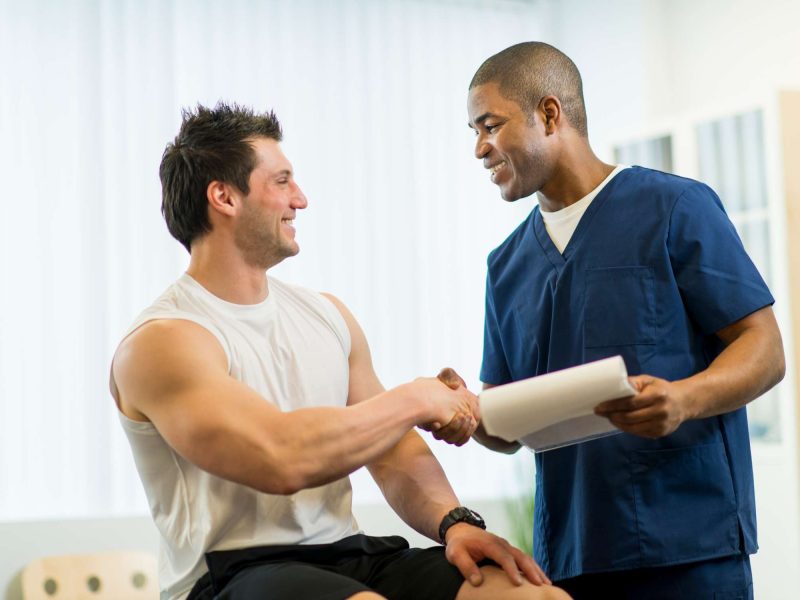 man and a therapist shaking hands - Capstone Physical Therapy and Fitness